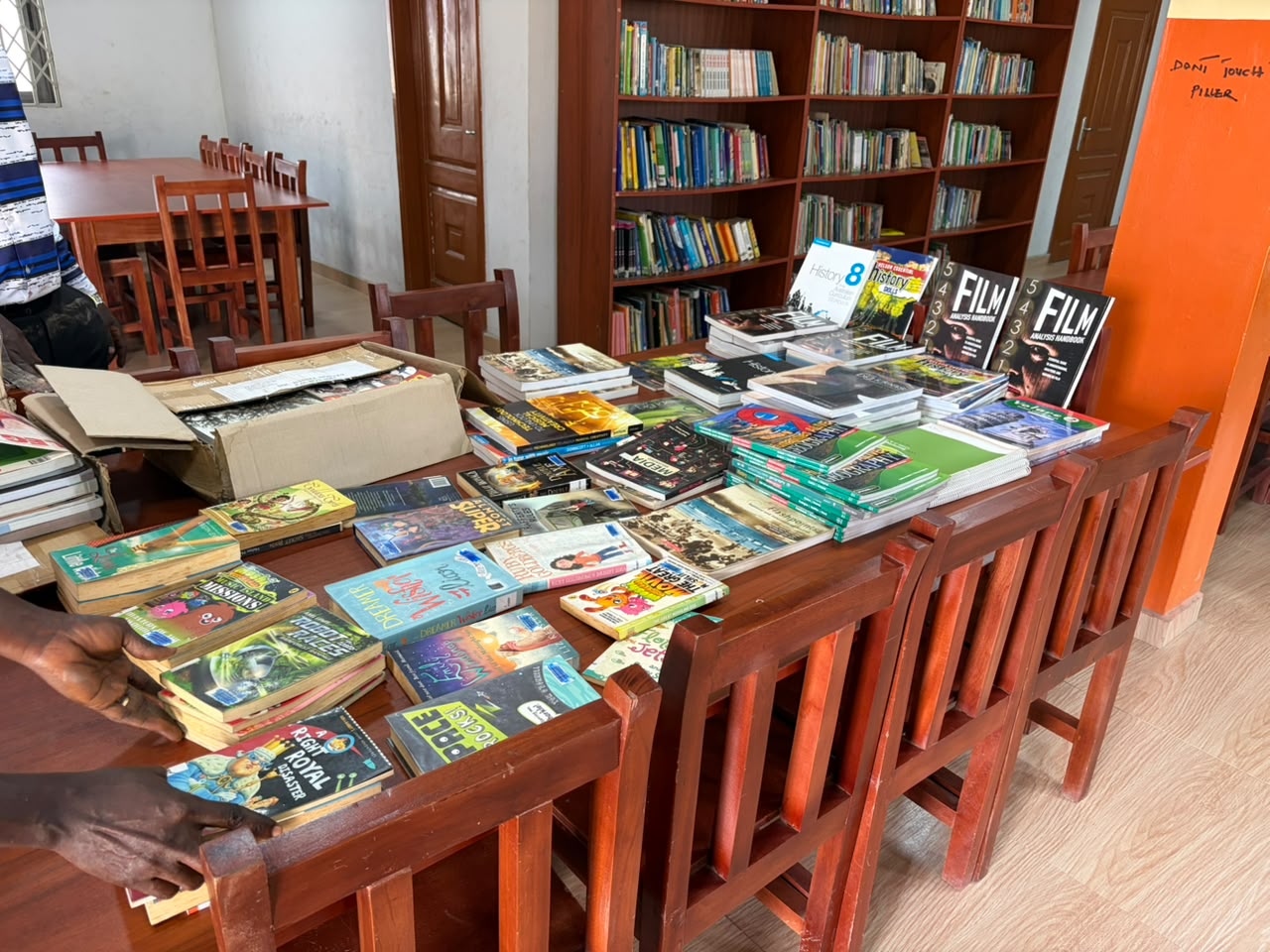 Donated books arranged across a table at the library.
