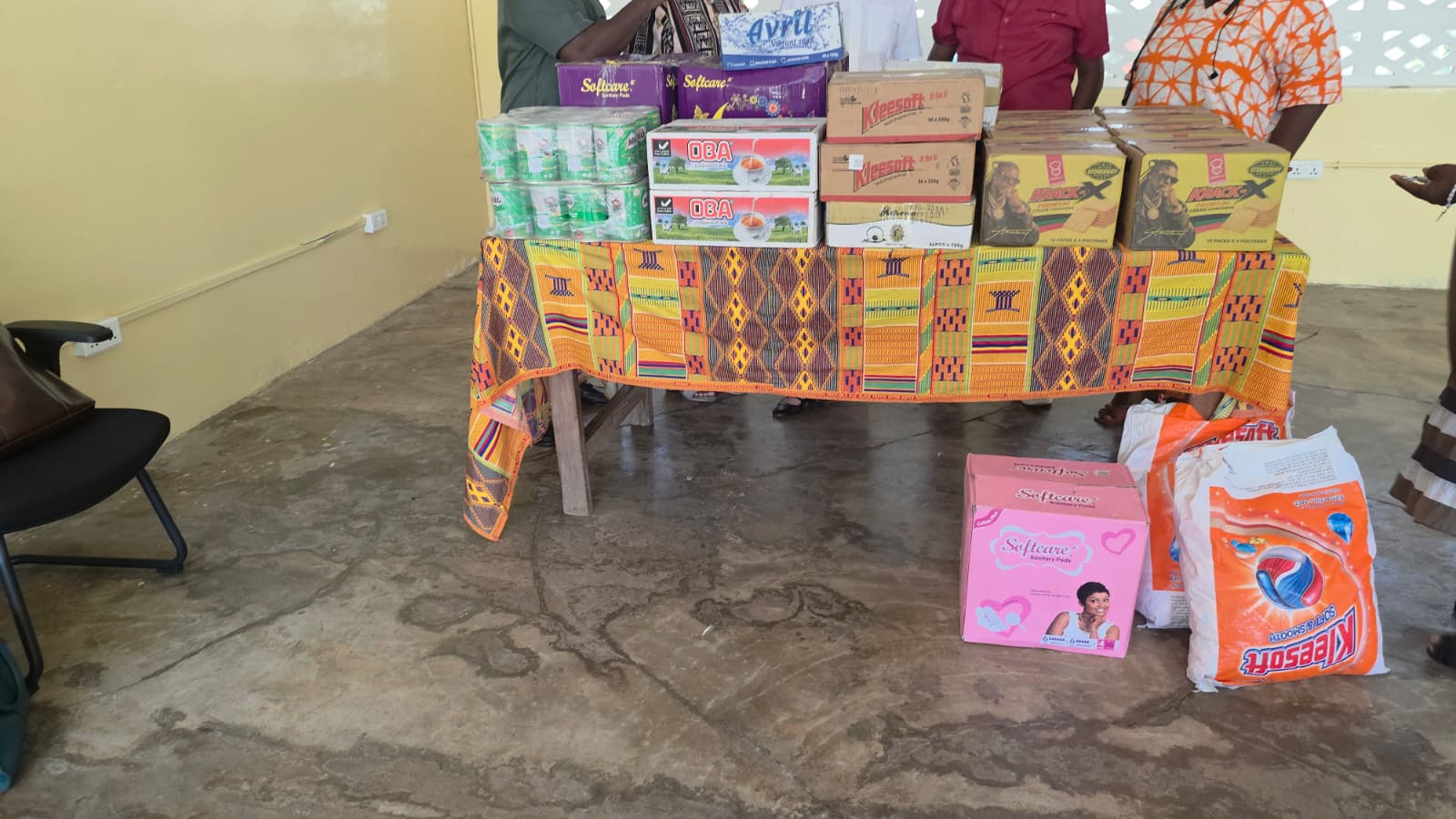 Food supplies and personal-care items displayed for presentation at the centre, with no faces visible.